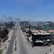 Smoke rises from clashes between Bedouin clans and Druze militias in southern Syria (Ghaith Alsayed/AP)